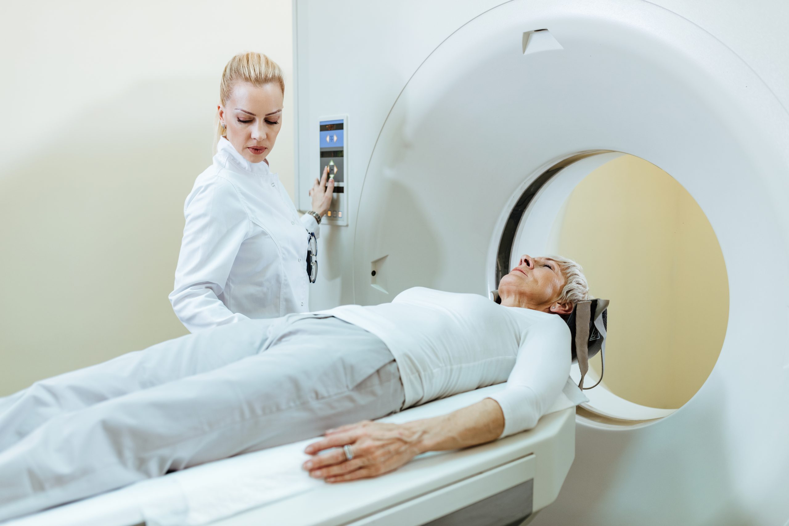 Doctor monitoring patient during CT scan